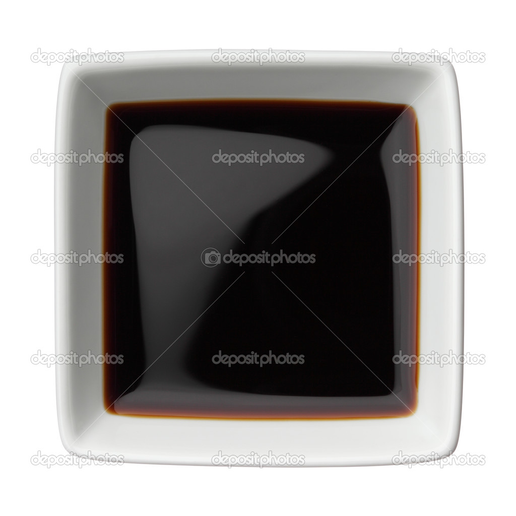 Soy sauce in a square bowl isolated on white