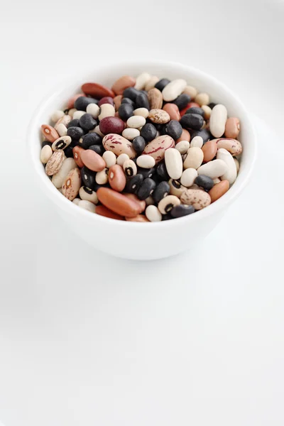 Assorted dried beans in a bowl isolated on white background — Stock Photo, Image