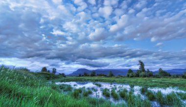 Mavi yatay, dramatik bulutlar dağ ve su