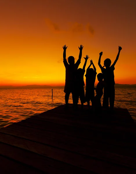 Silhouette of children at sunset — Stock Photo, Image