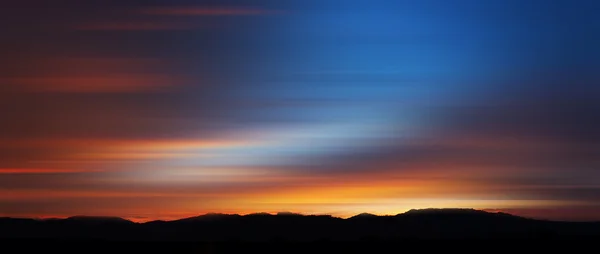 Motion blurred abstract of colorful sunset for background — Stock Photo, Image