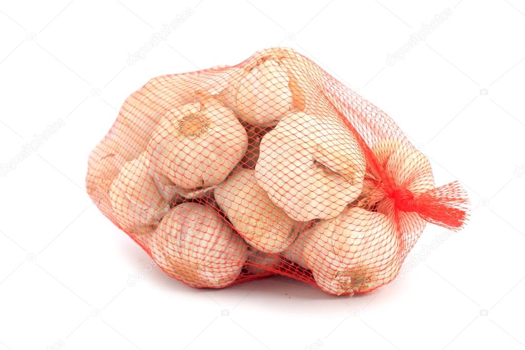 Garlic in a net over white background