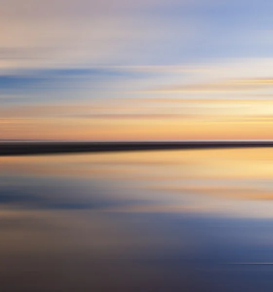 Reflection of colorful sunset with long exposure effect — Stock Photo, Image