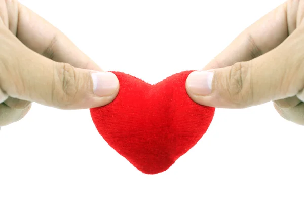 Hand holding small heart shaped pillow isolated on white — Stock Photo, Image