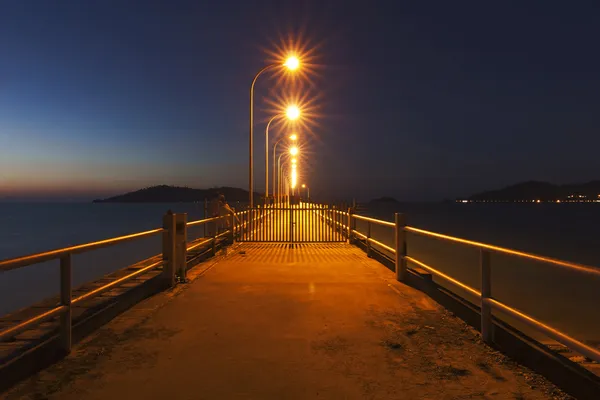 Jetty at sunset with star shaped streetlights — Stock Photo, Image