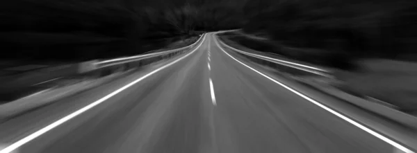 Asphalt road with zoom effect in black and white — Stock Photo, Image