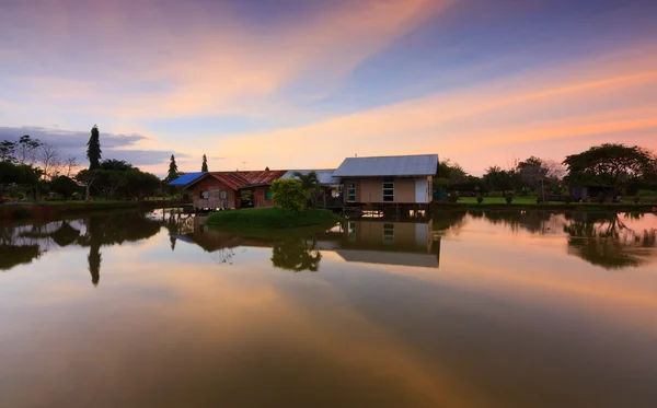 Reflection of a wooden cottage and colorful sunset at Sabah, Borneo, Malaysia — Stock Photo, Image