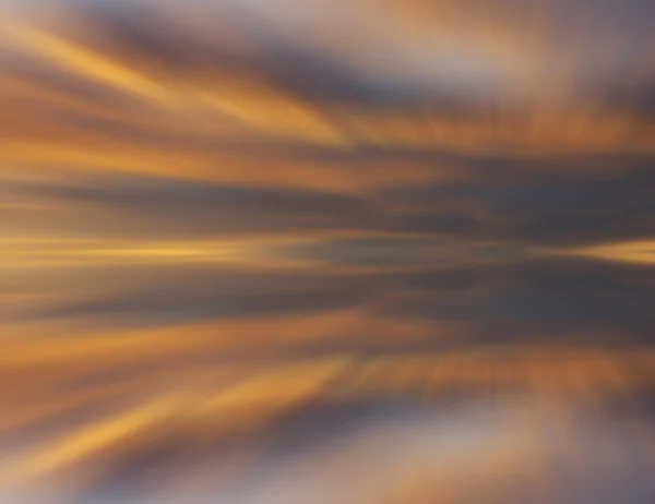 Reflection of colorful sunset clouds with long exposure effect, zoom blurred — Stock Photo, Image