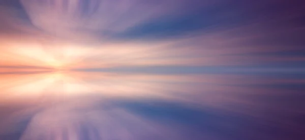 Reflection of clouds with long exposure effect, zoom blurred — Stock Photo, Image