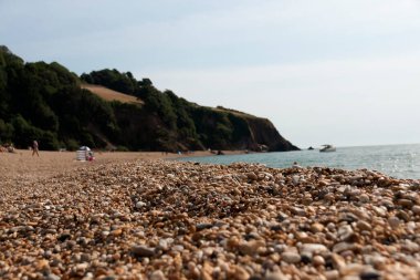 A close up view of the different pebbles on the beach at blackpool sands. 