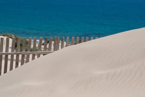 Dřevěné ploty na opuštěné písečné duny v tarifa, Španělskocercas de madera sobre las dunas de la playa desierta en tarifa, España — Stock fotografie