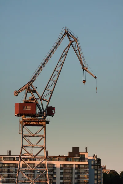 Sea port cranes with blue cloudy sky in background and water in — Stock Photo, Image