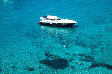 luxury yacht in turquoise Illetes Formentera mediterranean sea B clipart