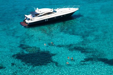 luxury yacht in turquoise Illetes Formentera mediterranean sea B clipart