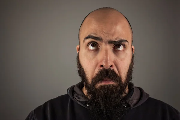 Bearded man doubtfully thinking — Stock Photo, Image