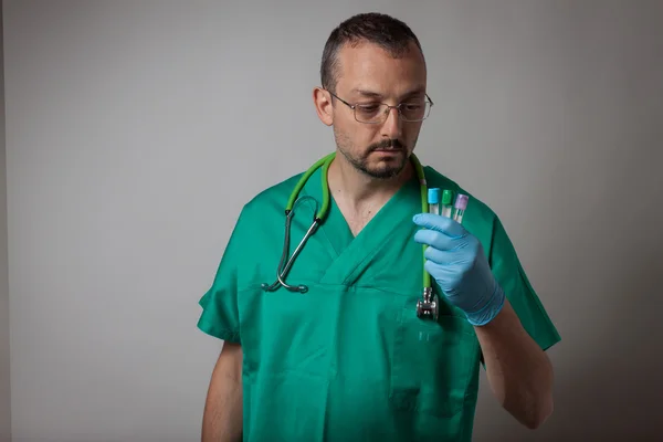 Portrait of a young physician with test tubes — Stock Photo, Image