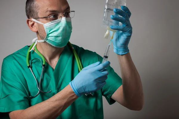 Portrait of a young physician with surgical mask — Stock Photo, Image