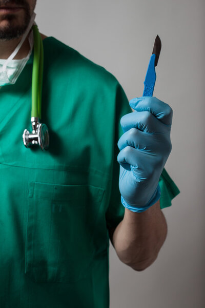 Physician holding a surgical knife