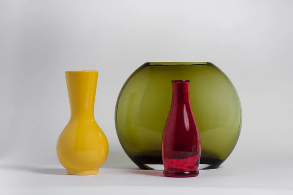 Still life of a bottle and vases — Stock Photo, Image