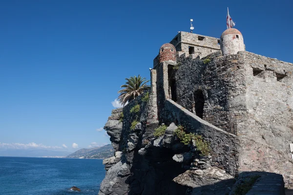 Ancient castle overhanging blue sea — Stock Photo, Image