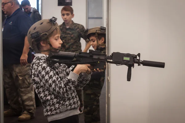 Young boy with softair rifle at Militalia 2013 in Milan, Italy — Stock Photo, Image