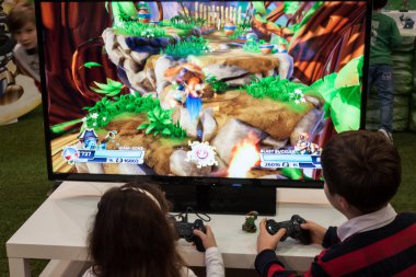 Children playing video games at G! come giocare in Milan, Italy clipart