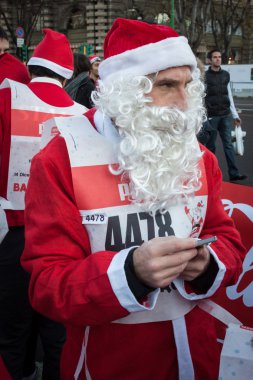 Almost 10.000 Santas take part in the Babbo Running in Milan, Italy clipart