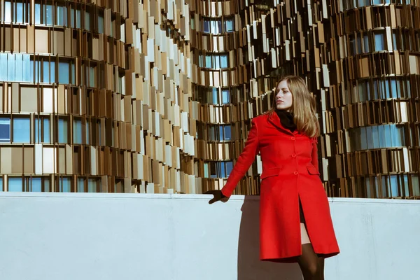 Beautiful girl posing with red coat — Stock Photo, Image