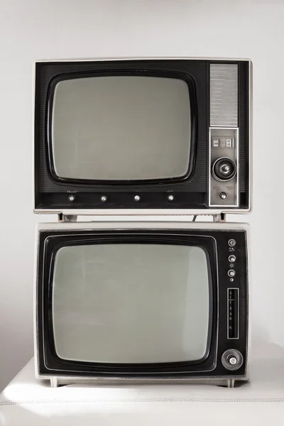 Two vintage televisions on white background — ストック写真