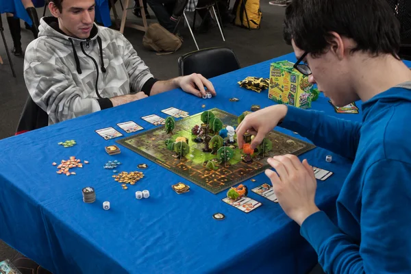 Dos chicos juegan un juego de mesa en la convención Festival del Fumetto en Milán, Italia —  Fotos de Stock