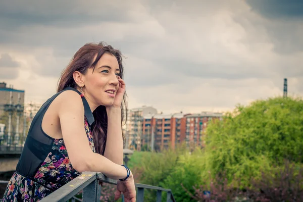 Pretty girl posing on railroad bridge — Stock Photo, Image