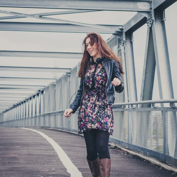 Pretty girl walking happy on a bridge — Stock Photo, Image