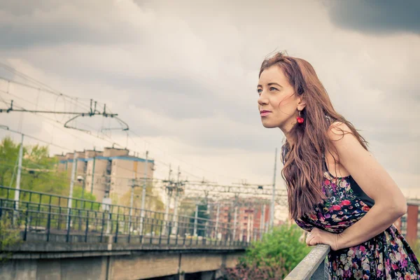 Pretty girl posing on railroad bridge — Stock Photo, Image