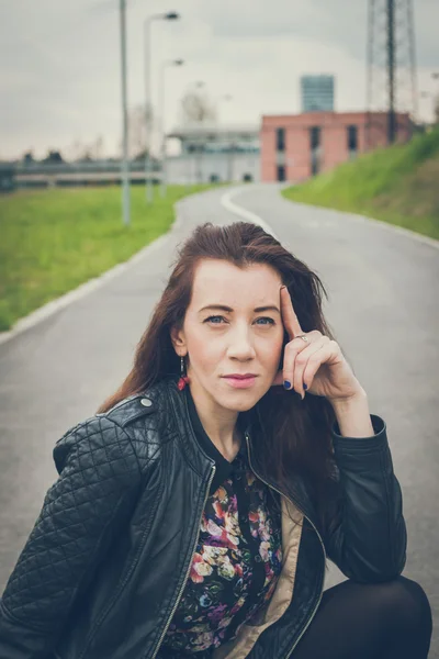 Pretty girl with long hair posing in the street — Stock Photo, Image