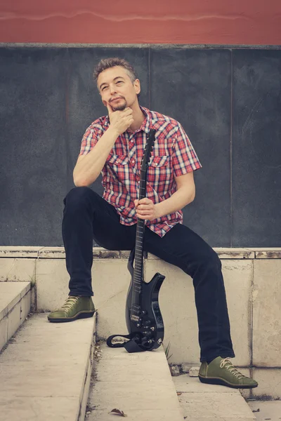 Man in short sleeve shirt playing electric guitar — Stock Photo, Image