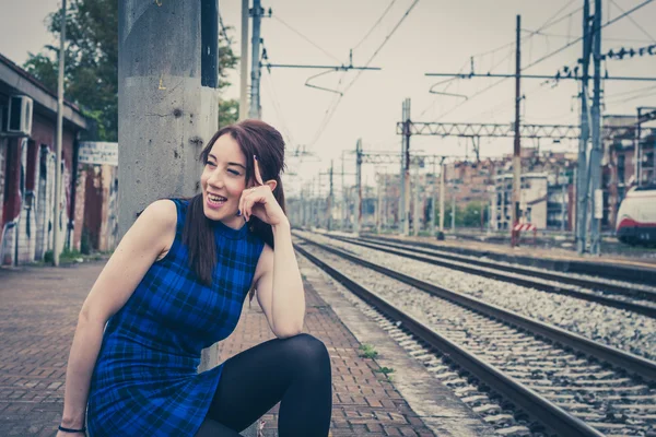 Pretty girl posing along the tracks — Stock Photo, Image