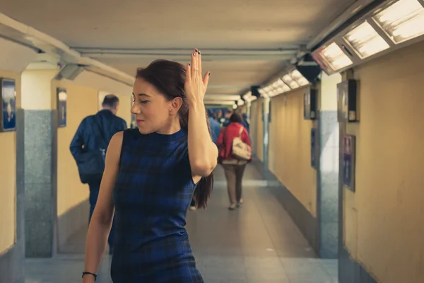 Pretty girl posing in railroad station underpass — Stock Photo, Image