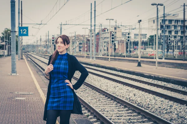 Pretty girl posing along the tracks — Stock Photo, Image