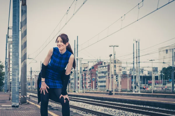 Pretty girl posing along the tracks — Stock Photo, Image