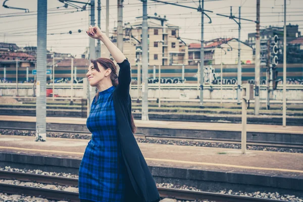 Pretty girl dancing along the tracks — Stock Photo, Image