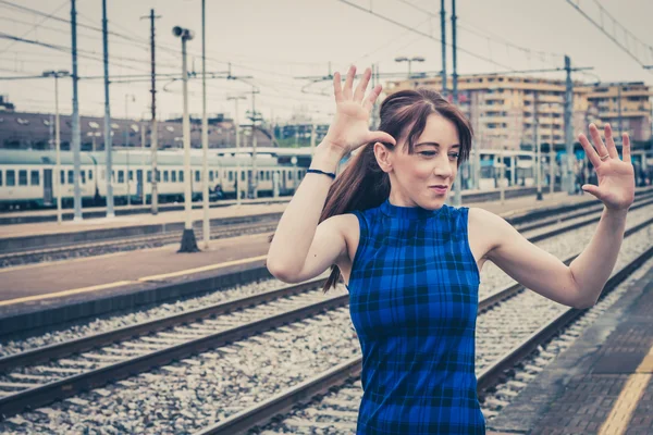 Pretty girl posing along the tracks — Stock Photo, Image