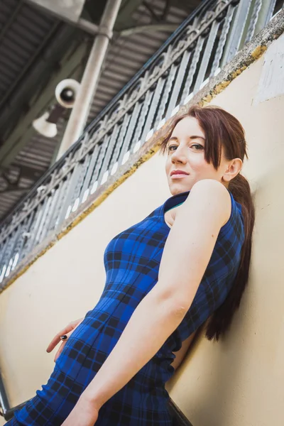 Pretty girl posing in railroad station underpass — Stock Photo, Image