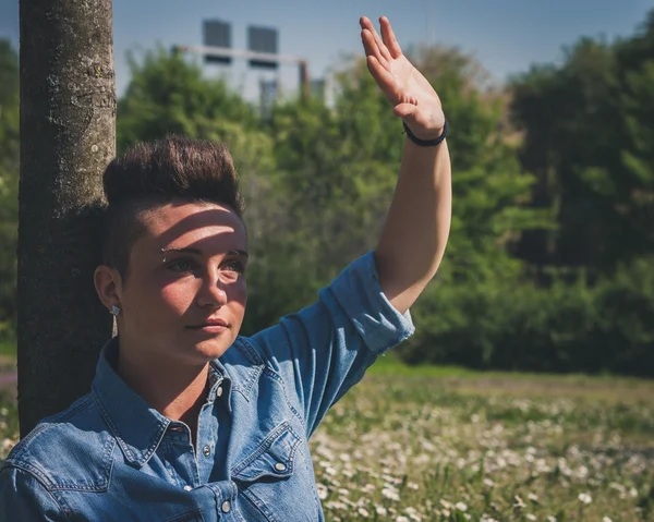 Short hair girl sitting in the grass — Stock Photo, Image