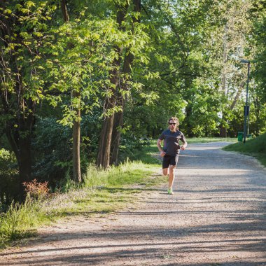 çalışan bir şehir parkında uzun saçlı atlet