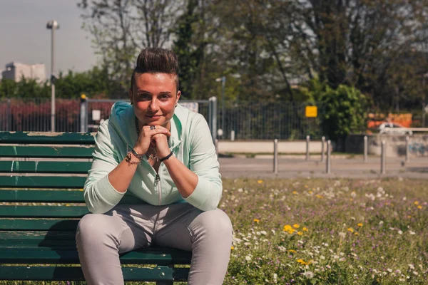 Portrait of a short hair girl sitting on bench — Stock Photo, Image