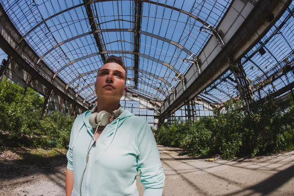 Fisheye portrait of short hair girl in an abandoned factory — Stock Photo, Image