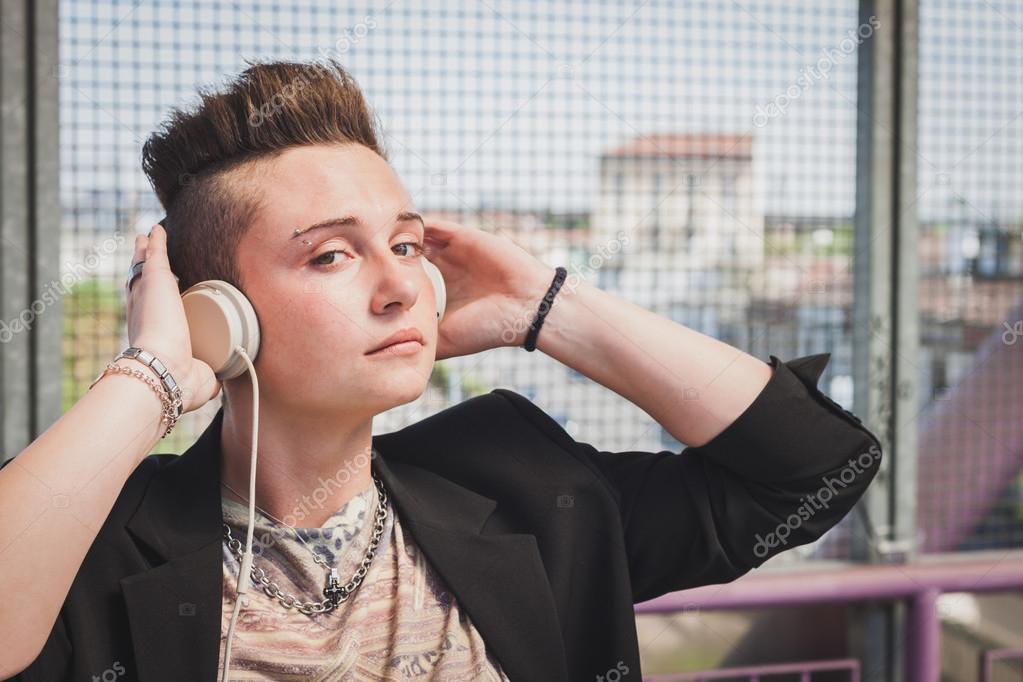 Pretty Short Hair Girl Listening To Music On A Bridge
