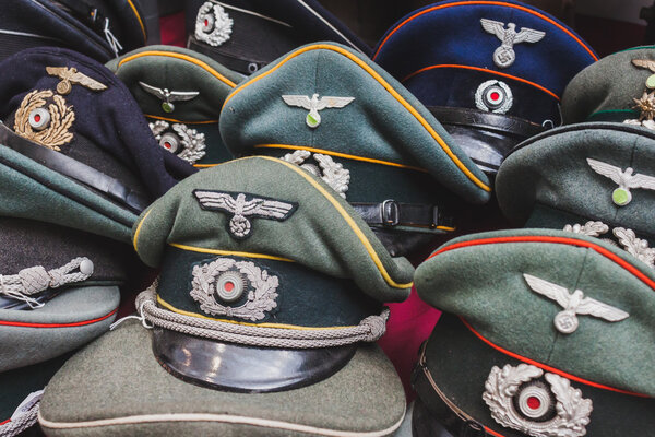 Wehrmacht visor caps on display at Militalia in Milan, Italy