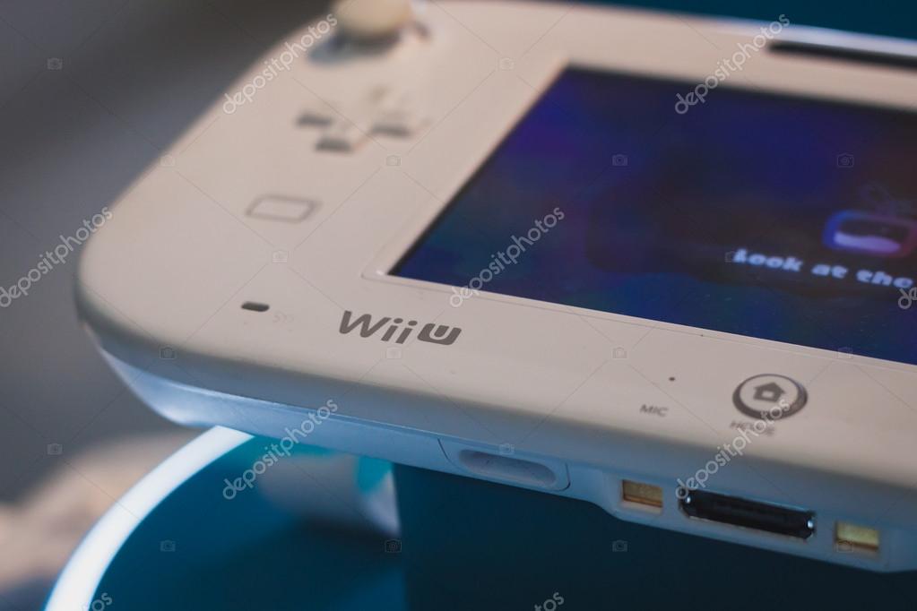 MILAN, ITALY - JULY 3, 2014: Close up of white Nintendo Wii U gamepad device. Nintendo is the world's largest video game company by revenue.