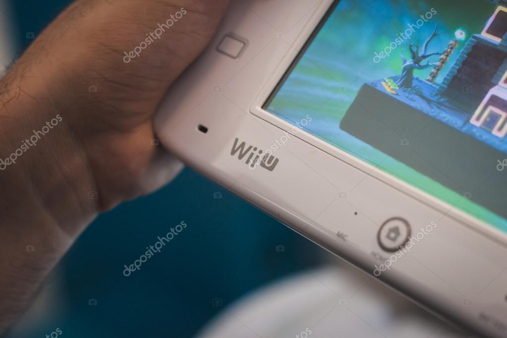 MILAN, ITALY - JULY 3, 2014: Close up of white Nintendo Wii U gamepad device. Nintendo is the world's largest video game company by revenue.